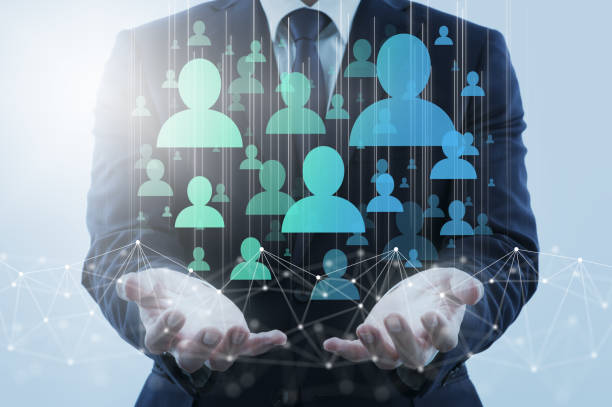 Business person holding network structure and customer icons.